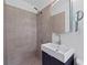 Modern bathroom featuring a tiled shower and floating sink vanity with decorative mirror at 1971 Hooper St, Decatur, GA 30032