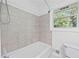 Bathroom featuring a tiled shower/tub combination and a toilet at 1971 Hooper St, Decatur, GA 30032