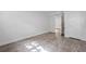 Room with wood-look floors, fresh paint, and a doorway to another room at 1971 Hooper St, Decatur, GA 30032