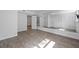 Modern room featuring wood-look floors, fresh paint, and a full-length wall mirror at 1971 Hooper St, Decatur, GA 30032