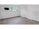 Bedroom with wood floors, window with natural light, and built-in closet for storage at 1971 Hooper St, Decatur, GA 30032