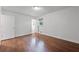 A bedroom with hardwood floors, natural light from the window, and a door to the bathroom at 1971 Hooper St, Decatur, GA 30032