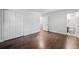 A large bedroom with hardwood floors, a large closet, and a door to the bathroom at 1971 Hooper St, Decatur, GA 30032
