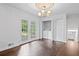 Bright dining room with hardwood floors, a closet washer/dryer, and French doors to the backyard at 1971 Hooper St, Decatur, GA 30032