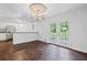 Dining room with a view of the modern kitchen, hardwood floors, and French doors to the yard at 1971 Hooper St, Decatur, GA 30032