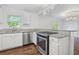 View of kitchen featuring stainless steel gas range, granite counters and white cabinets at 1971 Hooper St, Decatur, GA 30032