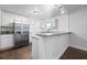 Kitchen with stainless steel refrigerator, white cabinets, and granite countertops at 1971 Hooper St, Decatur, GA 30032