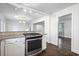 Updated kitchen with granite countertops, stainless gas range, and modern lighting at 1971 Hooper St, Decatur, GA 30032