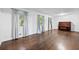 Living room with hardwood floors, piano, three windows and lots of natural light at 1971 Hooper St, Decatur, GA 30032