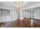 A living room with hardwood floors and a laundry closet with a modern washer and dryer unit at 1971 Hooper St, Decatur, GA 30032