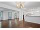 Open concept living area with hardwood floors connecting to a kitchen with stainless steel appliances at 1971 Hooper St, Decatur, GA 30032