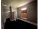 Bedroom with dark carpet, small window, and fireplace at 29 Ivy St, Porterdale, GA 30014