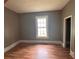 Bedroom featuring wood-look floors, neutral paint, and natural light from the large window at 29 Ivy St, Porterdale, GA 30014