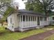 View of the exterior of the home, featuring an enclosed front porch with white lattice at 29 Ivy St, Porterdale, GA 30014
