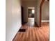 Hallway featuring wood-look floors, neutral paint, and an archway detail at 29 Ivy St, Porterdale, GA 30014