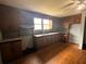 Kitchen featuring traditional cabinetry and wood floors with a view of the sink and window at 29 Ivy St, Porterdale, GA 30014