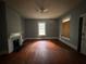 Cozy living room showcasing hardwood floors, ceiling fan, and decorative fireplace at 29 Ivy St, Porterdale, GA 30014