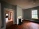 Inviting living room featuring hardwood floors, a fireplace, and classic architectural details at 29 Ivy St, Porterdale, GA 30014