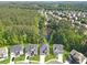 Aerial view of new homes surrounded by lush greenery and a tranquil pond, showcasing a peaceful setting at 411 Riverclub Rd, Acworth, GA 30101