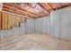 View of the unfinished basement featuring concrete walls, flooring and exposed ceiling insulation, offering potential for customization at 411 Riverclub Rd, Acworth, GA 30101