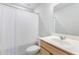 Bright bathroom with white shower curtain, vanity, and standard toilet at 411 Riverclub Rd, Acworth, GA 30101