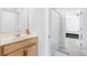 Bright bathroom featuring a light wood vanity and a shower/tub combo with neutral tones at 411 Riverclub Rd, Acworth, GA 30101