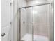 Bathroom shower with tile surround and glass door at 411 Riverclub Rd, Acworth, GA 30101