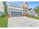 Side view of a well maintained two-story home with a two-car garage and lush green grass at 411 Riverclub Rd, Acworth, GA 30101