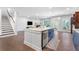 Open-concept kitchen features an island, stainless steel appliances, and seamless flow into the living area at 411 Riverclub Rd, Acworth, GA 30101