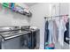 Laundry room area with modern washer and dryer and storage space for detergents at 411 Riverclub Rd, Acworth, GA 30101