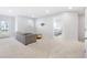 Spacious living room featuring a grey sofa, modern coffee table and adjacent bedroom at 411 Riverclub Rd, Acworth, GA 30101