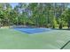 Outdoor tennis court provides an excellent recreational amenity within the community at 411 Riverclub Rd, Acworth, GA 30101