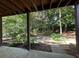 View of the backyard with lush greenery, trees, and a brick pathway at 4265 Lansmoore Xing, Suwanee, GA 30024