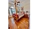 Bright bedroom features hardwood floors, large windows, and a four-poster bed at 4265 Lansmoore Xing, Suwanee, GA 30024