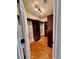 Walk-in closet with custom shelving, hardwood floors, and ample storage space at 4265 Lansmoore Xing, Suwanee, GA 30024