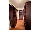 Well-organized walk-in closet features custom cabinetry, hardwood floors, and clothing rods at 4265 Lansmoore Xing, Suwanee, GA 30024