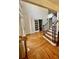 Inviting foyer boasts hardwood floors, staircase with detailed iron railings, and white trim at 4265 Lansmoore Xing, Suwanee, GA 30024
