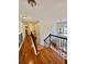 Upstairs hallway features hardwood floors, and wrought iron railing overlooking the foyer at 4265 Lansmoore Xing, Suwanee, GA 30024