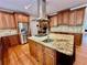 Spacious kitchen with stainless steel appliances, granite island with seating, and ample cabinet space at 4265 Lansmoore Xing, Suwanee, GA 30024