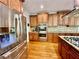 Updated kitchen with stainless steel appliances, a gas cooktop, and granite countertops at 4265 Lansmoore Xing, Suwanee, GA 30024
