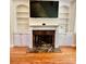 Cozy living room showcasing a fireplace with built-in shelving, perfect for gatherings at 4265 Lansmoore Xing, Suwanee, GA 30024