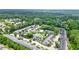 Aerial view of townhome community surrounded by lush greenery and mature trees at 4977 Meadow Ln, Marietta, GA 30068