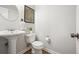 A powder room has a pedestal sink, a round mirror, and a decor map at 4977 Meadow Ln, Marietta, GA 30068