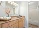 Bathroom featuring wooden vanity, tan countertop, framed mirror and separate shower-tub at 4977 Meadow Ln, Marietta, GA 30068