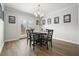 The dining room has a modern light fixture with a round table set for six at 4977 Meadow Ln, Marietta, GA 30068