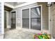 Cozy patio area featuring stone flooring, gray siding, flowers and a screened door at 4977 Meadow Ln, Marietta, GA 30068