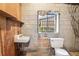 Basement bathroom with small sink, toilet and cinder block walls at 1260 Fork Creek Trl, Decatur, GA 30033
