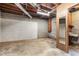 Unfinished basement area with utility sink and wood paneling at 1260 Fork Creek Trl, Decatur, GA 30033