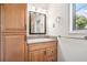 Bathroom featuring cabinets with granite counter, a mirror, and natural light from the window at 1260 Fork Creek Trl, Decatur, GA 30033
