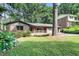 Traditional brick home with lush landscaping and a well-manicured lawn at 1260 Fork Creek Trl, Decatur, GA 30033